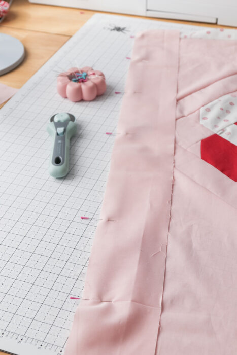 Careful pinning to ease pieced quilt center into precut border pieces