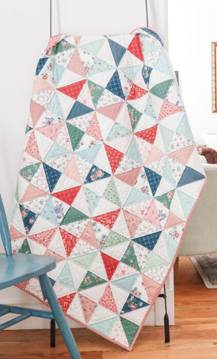 "Half-Square Triangle” is a Free Charm Square Baby Quilt Pattern designed by Amy Smart from Diary of a Quilter!