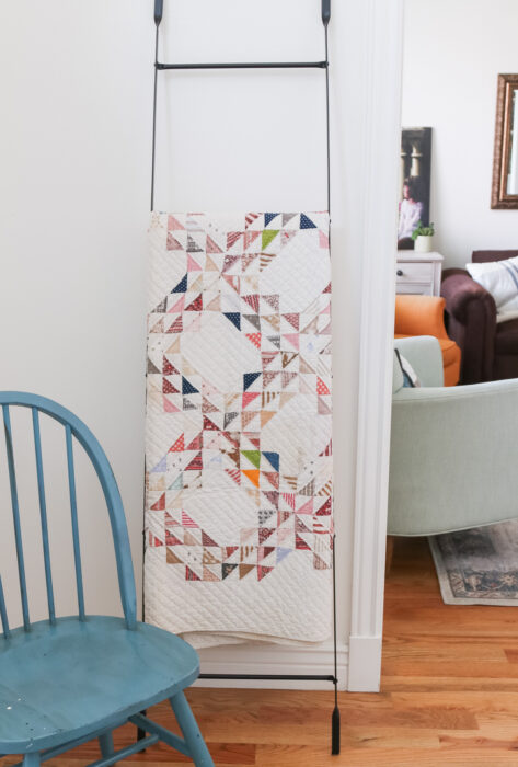 Decorating with Antique Ocean Waves quilt on a metal quilt display ladder