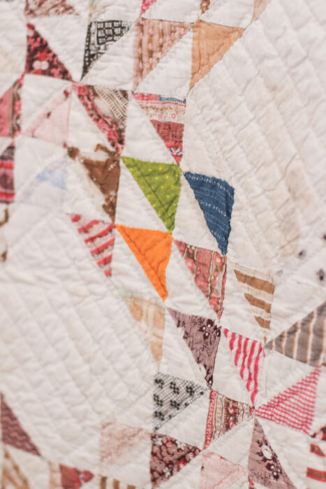 Antique Ocean Waves quilt - close up of vintage fabrics in half square triangles - using a bright zinger fabric