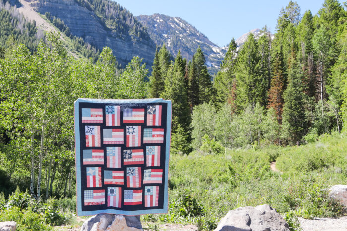 Fly the Flag quilt made by Amy Smart in front of Wasatch Mountains, Utah