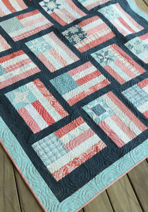 Fly the Flag - Americana quilt pattern by Amy Smart in faded reds, whites, blues with navy sashing