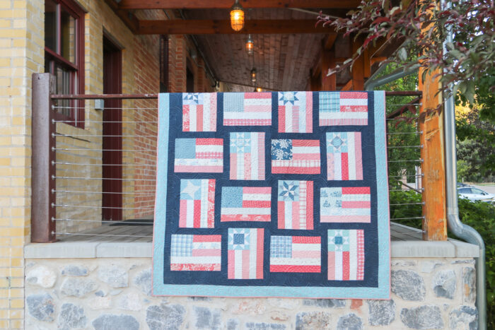 Fly the Flag - Americana quilt pattern by Amy Smart of Diary of a Quilter. Made with faded reds, whites, blues scraps with navy sashing