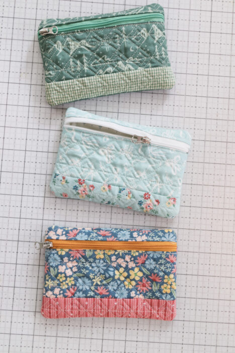 Lined zipper pouches made in a machine embroidery hoop with free pattern from Kimberbell